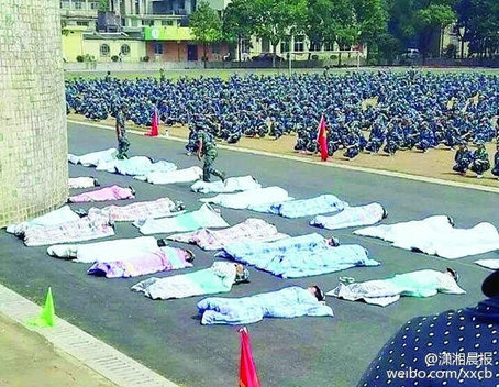 Weird punishment: College freshmen bathe in sunshine in quilts during military training