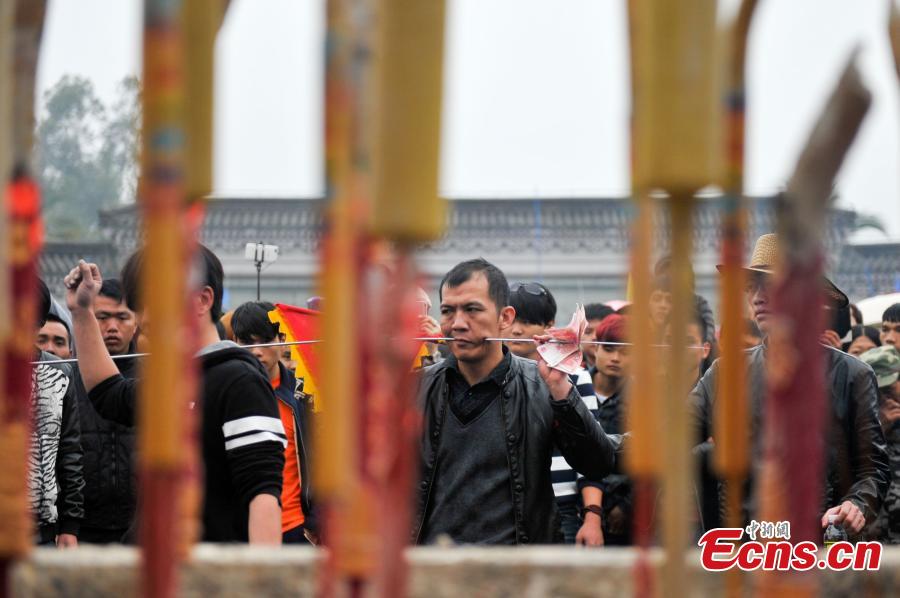Daring needle stunt a highlight of temple fair