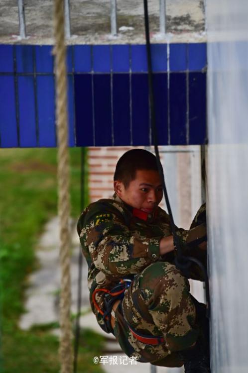 SWAT members run on the wet wall in training