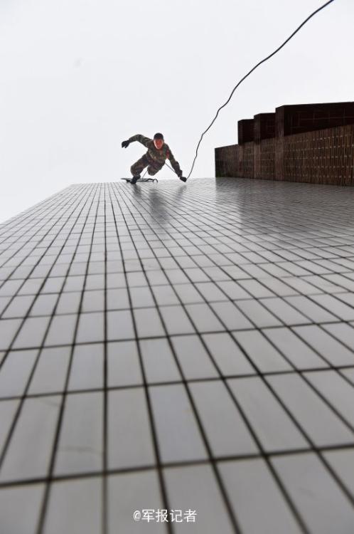 SWAT members run on the wet wall in training