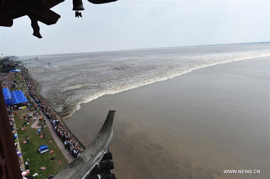 A tidal bore of the Qiantang River arrives in the town at its most heyday on Sept. 18.