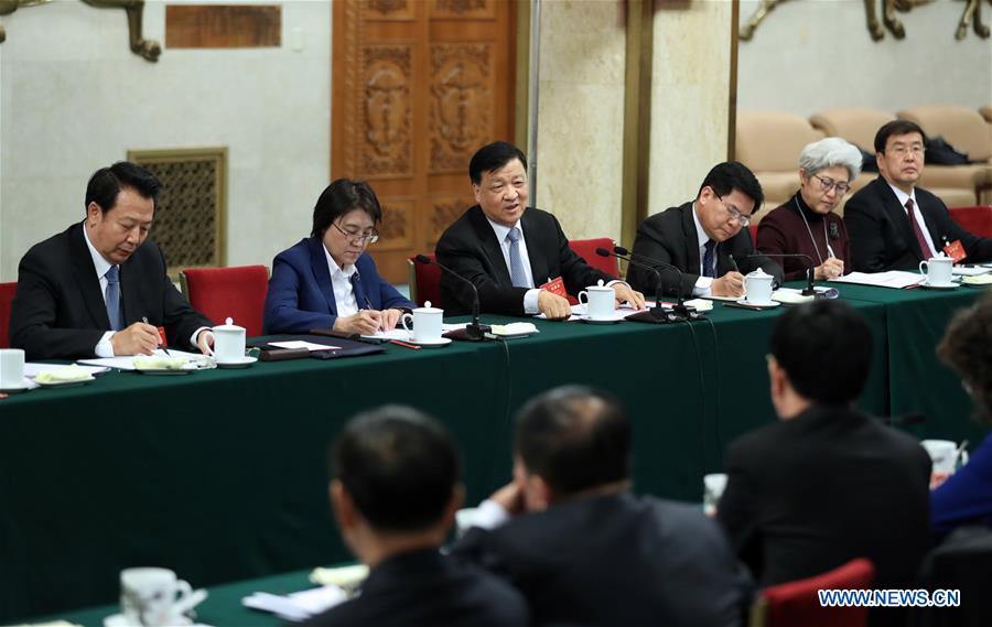 Chinese leaders review gov't work report with lawmakers