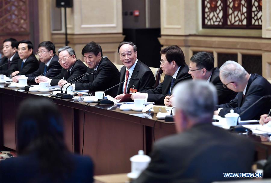 Chinese leaders review gov't work report with lawmakers