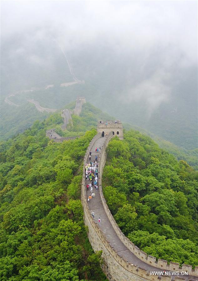People visit Mutianyu section of Great Wall in mist and rain in Beijing