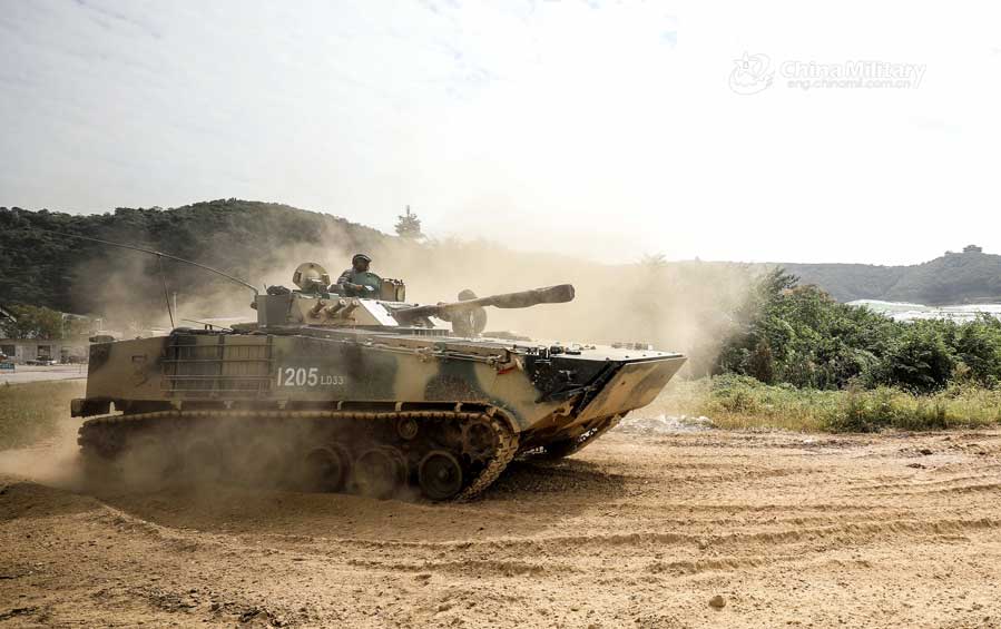 Infantry fighting vehicles drive through mire