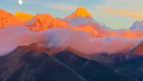 Radiant sunset illuminates snowy peaks