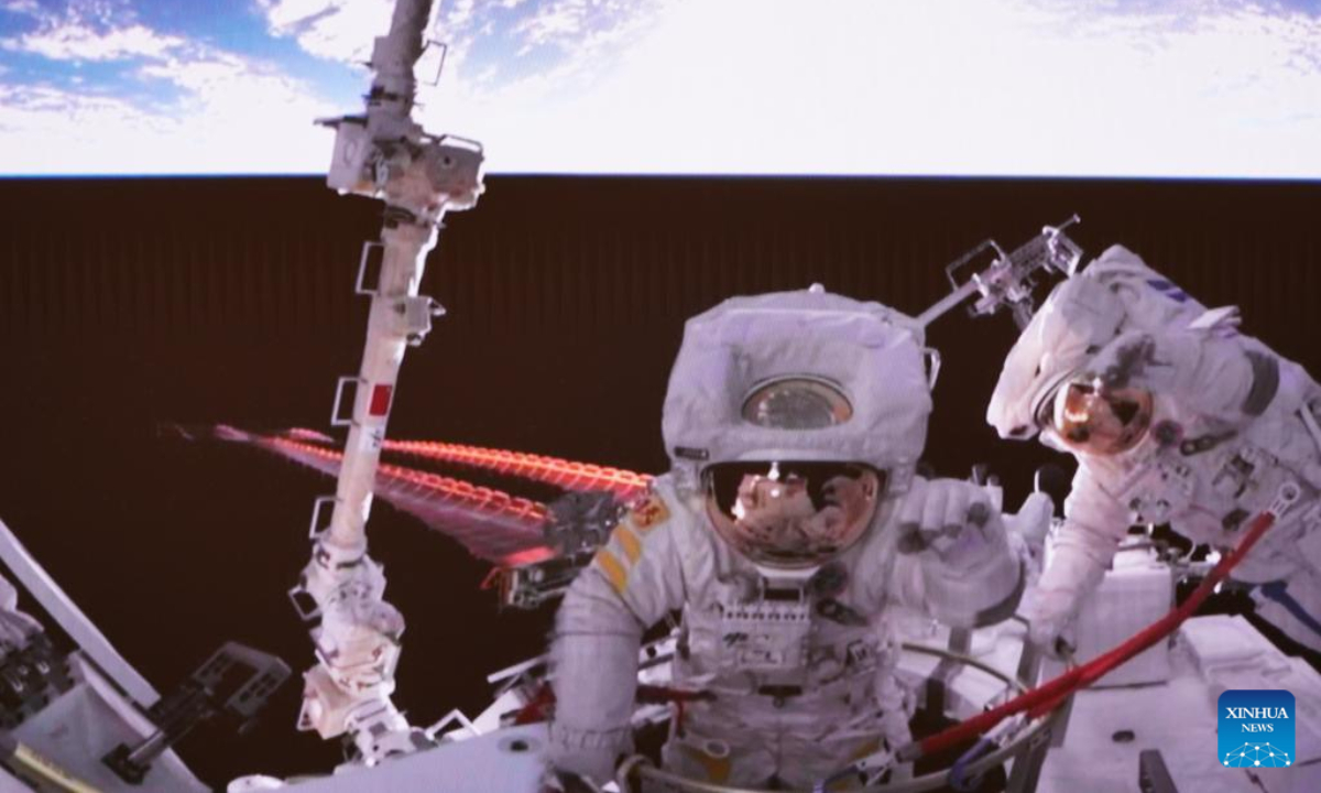 Screen image captured at Beijing Aerospace Control Center on Sept. 2, 2022 shows China's Shenzhou-14 astronauts Chen Dong (R) and Liu Yang waving before returning to the space station lab module Wentian after completing extravehicular activities (EVAs). Photo:Xinhua