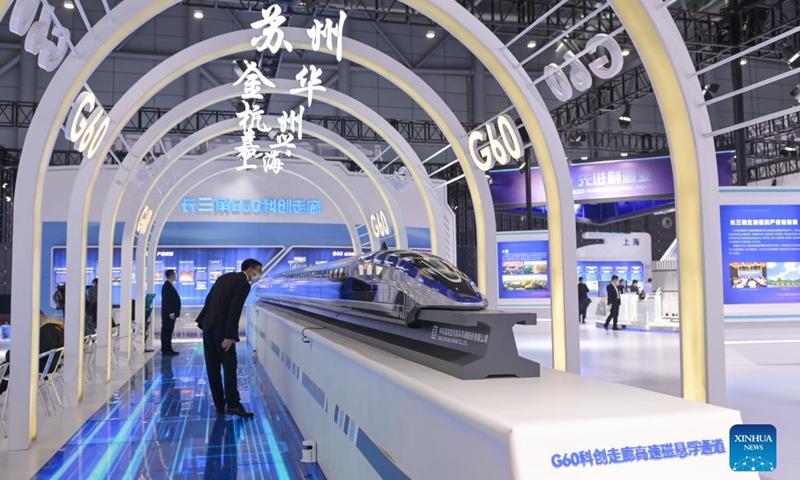 People look at a high-speed maglev train model on display at the fourth World Manufacturing Convention in Hefei, east China's Anhui Province, Nov. 19, 2021. The fourth World Manufacturing Convention kicked off Friday in Hefei, capital of east China's Anhui Province. The four-day event, themed innovation-driven, digitally empowered: global manufacturing industry aligned for high-quality growth, aims to promote high-quality manufacturing and deepen exchanges between China and the rest of the world. (Xinhua/Han Xu)
