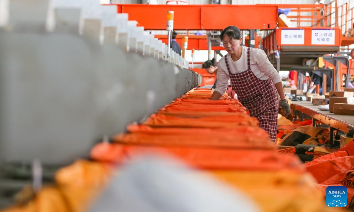 Staff members sort packages at a logistic center of YTO Express in Jurong City, east China's Jiangsu Province, Nov. 11, 2024. Manufacturers, e-commerce platforms and logistics companies across the country are busy coping with customer's demand during China's annual Double 11 shopping festival. (Photo: Xinhua)