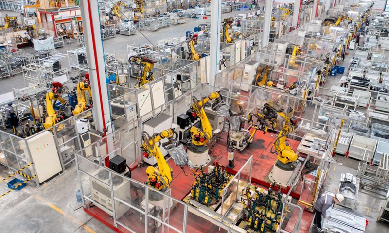 An aerial drone photo taken on Jan. 8, 2024 shows robotic arms processing components for new energy vehicles at a private company in Changxing Economic and Technological Development Zone of Huzhou City, east China's Zhejiang Province. (Photo by Tan Yunfeng/Xinhua)
