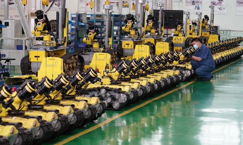 A worker debugs a special robot at a workshop in the Tangshan Hi-tech Industrial Development Zone in Tangshan, north China's Hebei Province, July 17, 2020.(Photo: Xinhua)