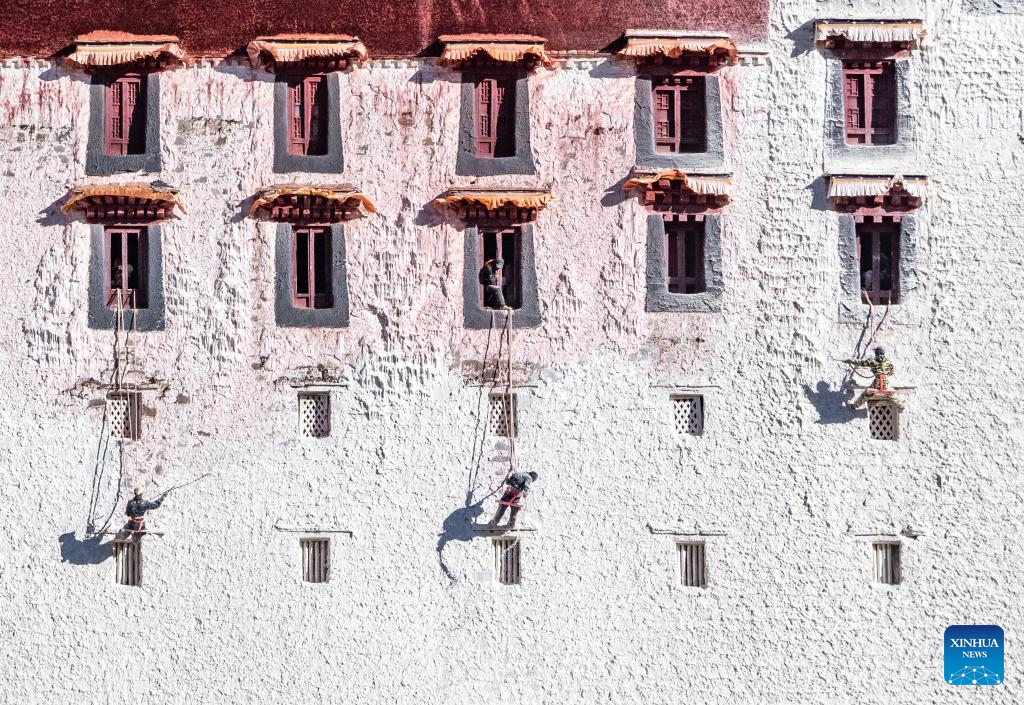 Workers paint wall of Potala Palace during annual renovation in China's Xizang